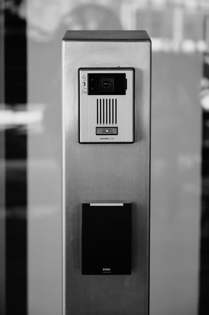 Services Minimalist black and white photo of an intercom system on a building facade in Boise.